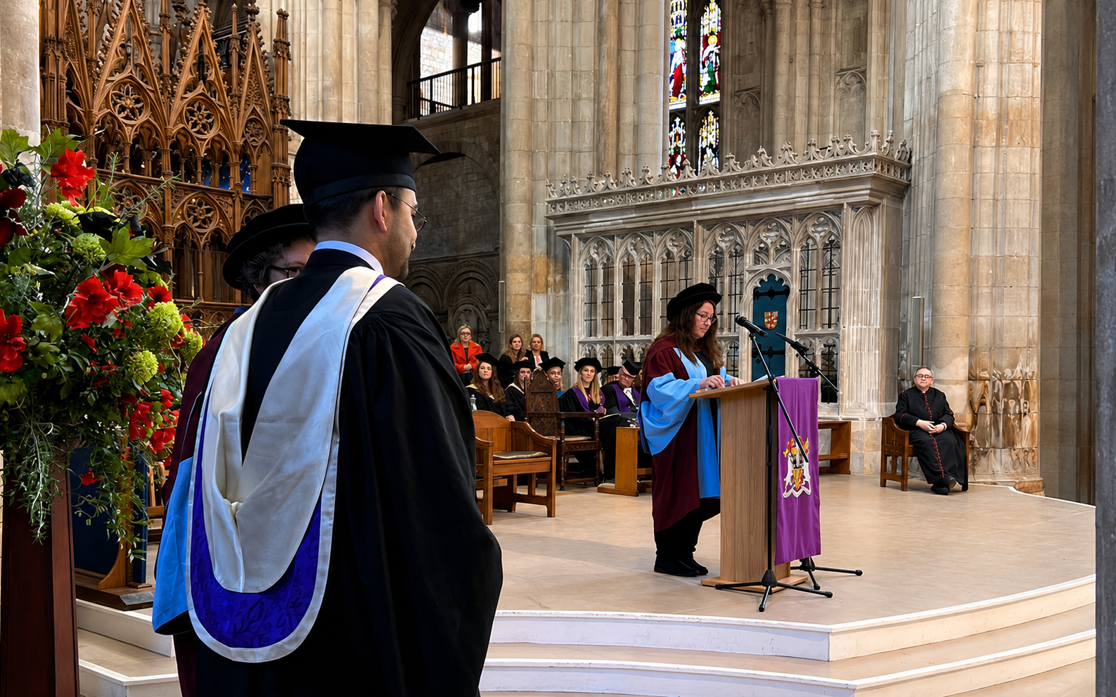 A graduation ceremony in progress inside a cathedral venue