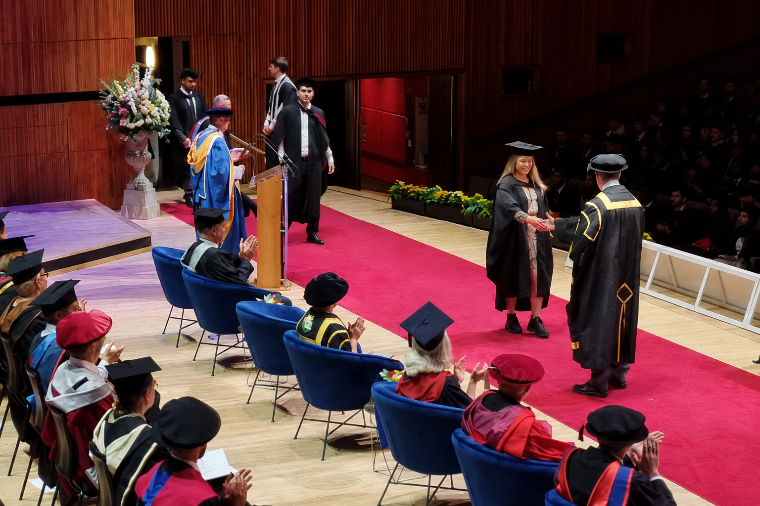 A Westminster graduation ceremony in progress with a graduate crossing the stage